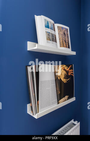 Open books on wall mounted reading stands Stock Photo
