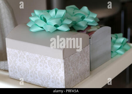Beautiful homemade caskets stand on the table. Caskets for storing jewelry. Stock Photo