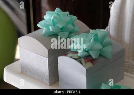 Beautiful homemade caskets stand on the table. Caskets for storing jewelry. Stock Photo