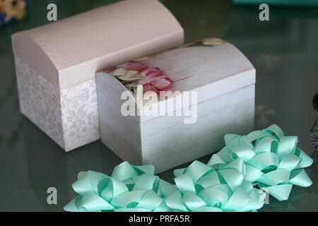 Beautiful homemade caskets stand on the table. Caskets for storing jewelry. Stock Photo