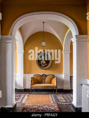 Sheraton style settee with 18th century portrait Stock Photo