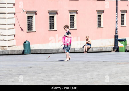 Warsaw, Poland May 31, 2018: Polish Blind woman walking near The Royal Castle of Warsaw in the city center. Poland Stock Photo