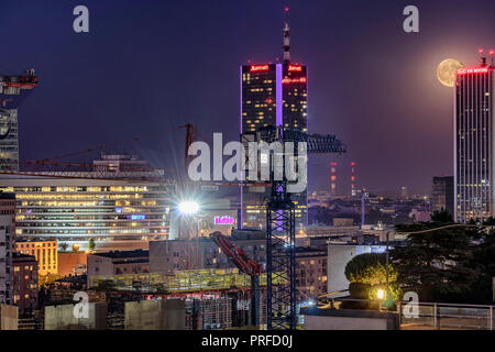 Warsaw, Poland May 30, 2018: Night panorama of Warsaw with new constructions, at night with moon rising from behind of a skyscraper Stock Photo