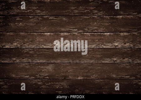 A dark and rustic wood table background, top down view. Stock Photo