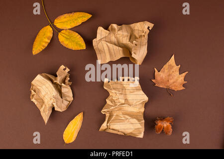 Notepad and crumpled sheets for writing, difficult work to write a letter. Free space for text. Autumn atmosphere and yellow leaves. Top view. Copy sp Stock Photo