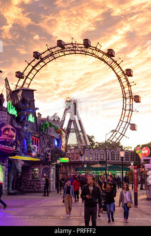 Vienna Swing Ride Vienna: fiery sunset at amusement park Prater with Praterturm (swing ...
