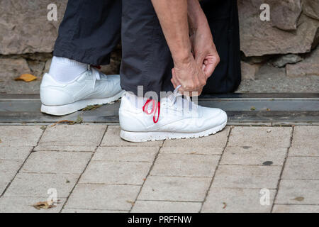 Man lacing running shoes before workout. Close up. Fitness and healthy lifestyle concept Stock Photo