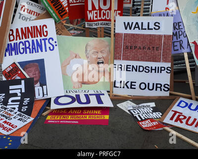 London UK, 13th July 2018. 100,000 people protest against the visit of the US President Donald Trump. The protesters gather in Trafalgar Square. Placards are left against a fence. Stock Photo