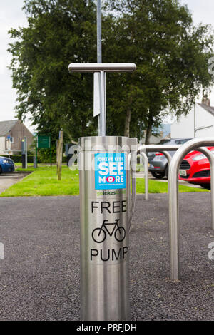 Fixed bicycle tyre air pump sited on Coniston Village car park adjacent to the tourist information office, Coniston in the English Lake District. Stock Photo