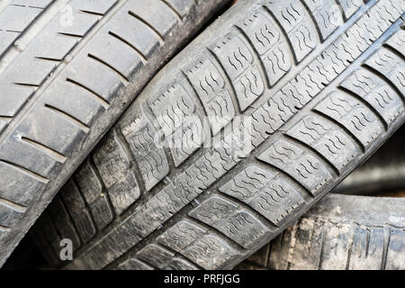 Various old car tires lying on each other. Evironmental friendly recycling concept. Stock Photo