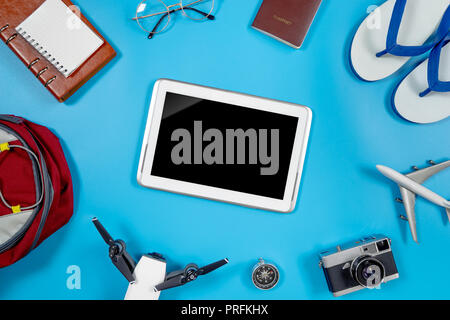 Blank Tablet screen surrounding by summer travel objects Stock Photo