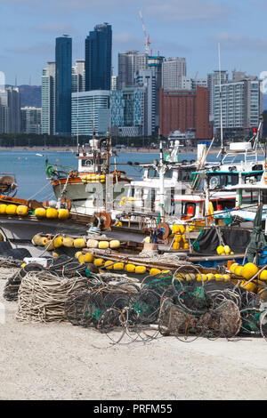 Cityscape of Busan with fishing boats with yellow floats. South Korea Stock Photo