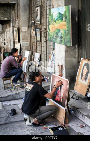 Portrait painters at work in the streets of old Batavia, Jakarta, Indonesia Stock Photo