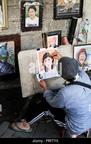 Portrait painter at work in the streets of old Batavia, Jakarta, Indonesia Stock Photo