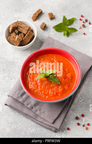 Tomato soup in a ceramic bowl on a napkin with slices of toast Stock Photo