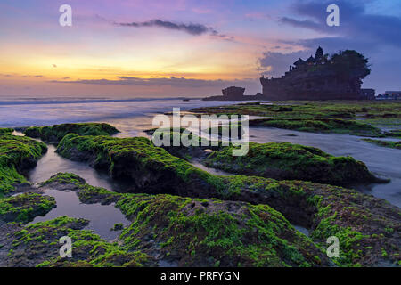 Sunset over Tanah Lot temple in Canggu, Bali, Indonesia. Stock Photo