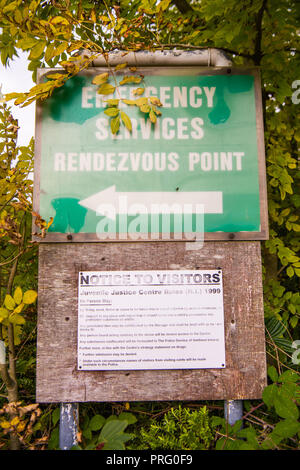 Sign for the emergency services rendezvous point and a notice to visitors warning them about what they cannot bring onto the site. Stock Photo