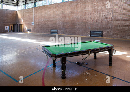 Broken pool snooker table in an abandoned gymnasium. Stock Photo