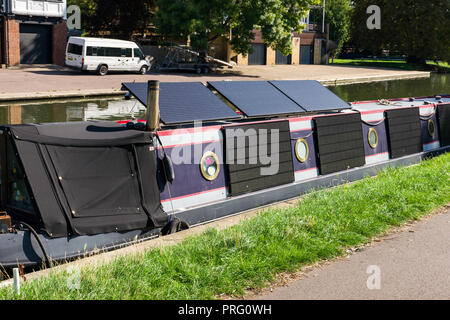 Several solar panels collecting energy on the exterior of a narrowboat moored on the river Cam, Cambridge, UK Stock Photo