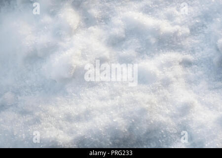Snow cover with texture of snowflakes and ice crystals. Background image, close-up. Stock Photo