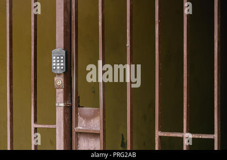 metal fence with a code intercom on the gate. Stock Photo