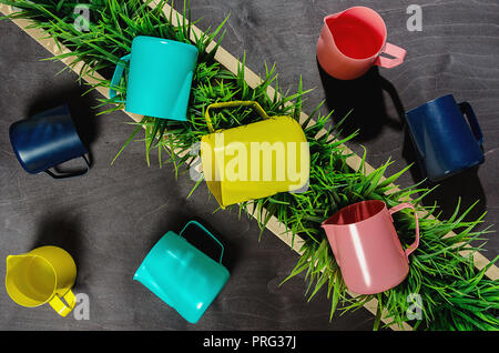 pitchers for baristas different colors. Stock Photo
