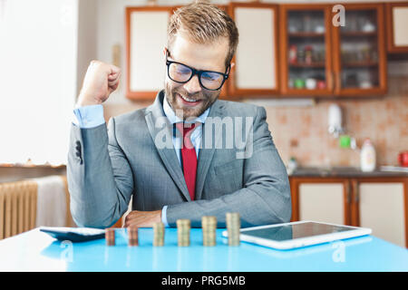Working from home. Young businessman checking on returns from his investment Stock Photo