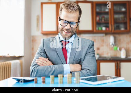Working from home. Young businessman checking on returns from his investment Stock Photo