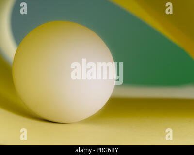 White marble ball in green and yellow, abstract background. Stock Photo