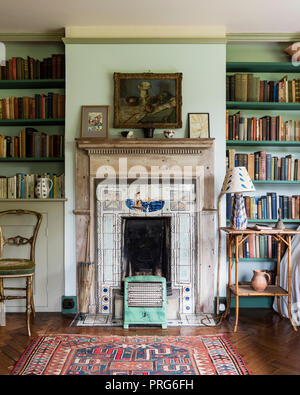 Bookshelves and fireplace in cottage, once home to Virgina Wolfe Stock Photo