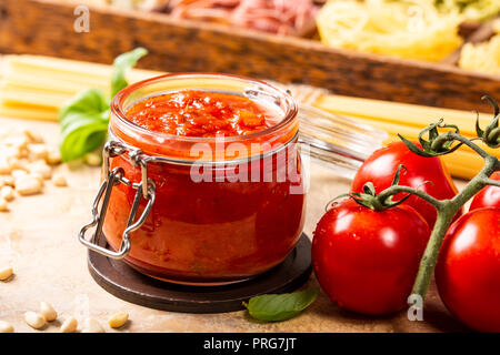 Glass jar with homemade classic spicy tomato pasta or pizza sauce. Stock Photo