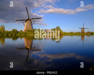 Autumn golden hour light on the windmills, canals and polders of Kinderdijk, near Rotterdam, Netherlands Stock Photo