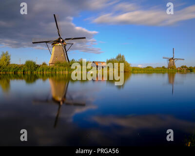 Autumn golden hour light on the windmills, canals and polders of Kinderdijk, near Rotterdam, Netherlands Stock Photo