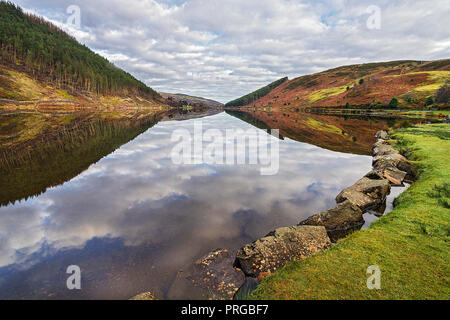 Reflections in Llyn Geirionydd in the Gwydir Forest looking north near Llanwrst Snowdonia National Park North Wales UK November 5294 Stock Photo