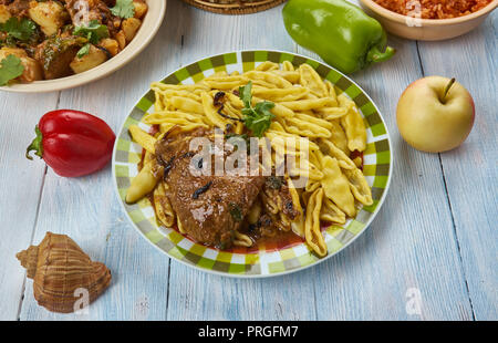Pasticada,stewed beef dish cooked in special sauce, popular in Croatia.  Balkan cuisine cuisine, Traditional assorted dishes, Top view. Stock Photo
