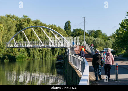 The pedestrian Riverside Bridge across the river Cam with people walking across it, cambridge, UK Stock Photo