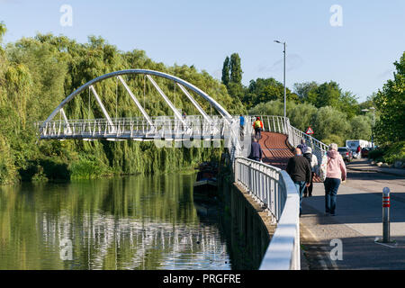 The pedestrian Riverside Bridge across the river Cam with people walking and cycling across it, cambridge, UK Stock Photo