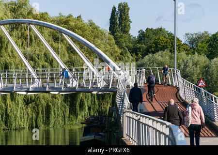 The pedestrian Riverside Bridge across the river Cam with people walking and cycling across it, cambridge, UK Stock Photo