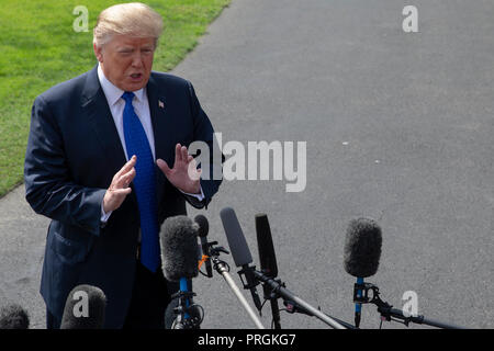 Washington, DC. 2nd Oct, 2018. United States President Donald J. Trump speaks with members of the media prior to boarding Marine One for his departure from the White House on October 2, 2018 in Washington, DC. Photo Credit: Alex Edelman/CNP | usage worldwide Credit: dpa/Alamy Live News Stock Photo
