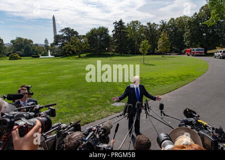 United States President Donald J. Trump speaks with members of the media prior to boarding Marine One for his departure from the White House on October 2, 2018 in Washington, DC. Photo Credit: Alex Edelman/CNP/MediaPunch Stock Photo