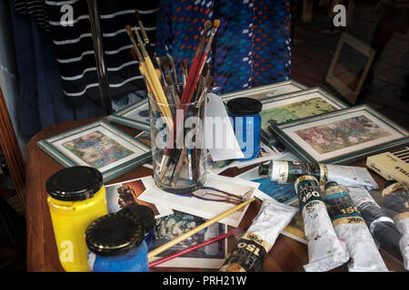 Set of paintbrushes and oil paints in artist studio Stock Photo
