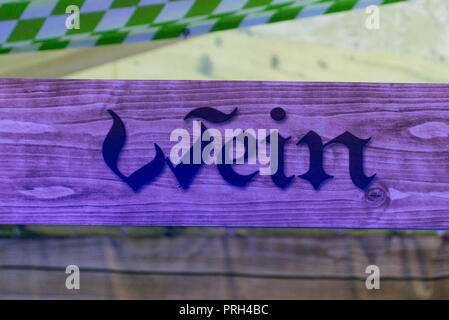 wooden signs from a bar at the german oktoberfest referring to the wine area where people can buy alcohol. Stock Photo