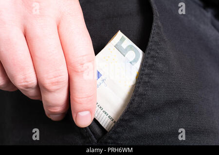 Male Hand Grabbing A 50 Euro Bill Out Of The Pocket Of A Black Jeans Trouser- Poor Man Concept Stock Photo