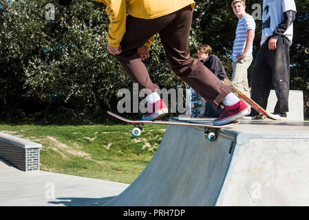 A skateboarder pushing off from a deck at Concrete Waves in Newquay in Cornwall. Stock Photo