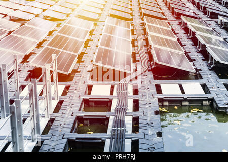 floating solar farm or FPV array of solar panels on water lake river pond Stock Photo