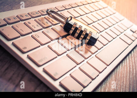 Black Combination Lock On A White Keyboard - Secure Computer Login Concept Stock Photo