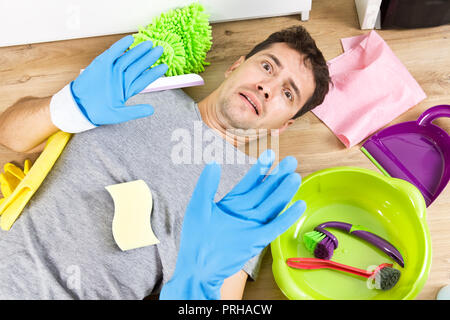 Stressed young men during cleaning. He has enough housekeeping Stock Photo