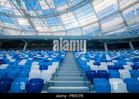 Cement stairs and blue seats inside football stadium Stock Photo
