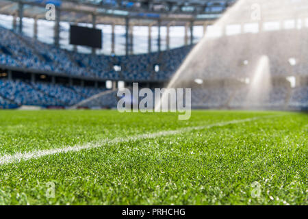 Dew on the artificial grass at empty stadium. Stock Photo