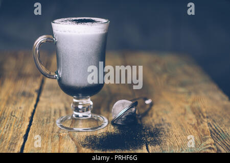 BLACK GOTH/GOTHIC CHARCOAL LATTE. Autumn Halloween coffee drink. Close up Stock Photo